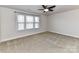 This bedroom features neutral carpeting and a ceiling fan at 4505 Plicata Dr, Indian Land, SC 29707