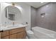 Modern bathroom featuring a soaking tub, tiled shower, wooden vanity, and round mirror at 4531 Rockford Ct, Charlotte, NC 28209