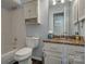 Bathroom featuring tub, toilet, granite countertop vanity, and dark flooring at 5009 Sharon Rd # E, Charlotte, NC 28210