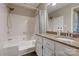 Bathroom featuring tub with gold fixtures, tiled walls, granite countertop vanity, and dark flooring at 5009 Sharon Rd # E, Charlotte, NC 28210