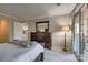 Bright bedroom featuring a dresser, access to a patio, and a glimpse of the kitchen at 5009 Sharon Rd # E, Charlotte, NC 28210