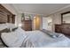 Well-lit bedroom with two dressers and a view of the entryway and kitchen areas at 5009 Sharon Rd # E, Charlotte, NC 28210