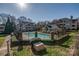 Aerial shot of the pool area shows lush landscaping and surrounding buildings at 5009 Sharon Rd # E, Charlotte, NC 28210