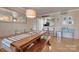 Dining room with wood table, bench seating, modern pendant lighting and an eat-in kitchen view at 5009 Sharon Rd # E, Charlotte, NC 28210