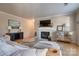 Spacious living room featuring a fireplace, comfortable sectional, and hardwood floors, with bright light at 5009 Sharon Rd # E, Charlotte, NC 28210