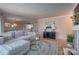 Inviting living room featuring a comfortable sectional sofa, hardwood floors, and an open layout to the dining area and kitchen at 5009 Sharon Rd # E, Charlotte, NC 28210