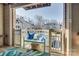 Inviting outdoor patio features a cozy seating area with plush blue pillows overlooking manicured community grounds at 5009 Sharon Rd # E, Charlotte, NC 28210