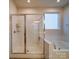 Bathroom featuring a glass enclosed shower, a tub, and white subway tile at 5028 Colline Ct, Charlotte, NC 28216