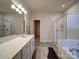 Bathroom featuring a glass shower, tub, and double vanity with modern lighting at 5028 Colline Ct, Charlotte, NC 28216