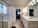 Bathroom featuring a tub, double vanity, and an open doorway to the main bedroom at 5028 Colline Ct, Charlotte, NC 28216