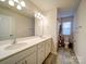 Bright bathroom featuring double sinks, ample counter space, and a shower-tub combination at 5028 Colline Ct, Charlotte, NC 28216