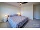 Clean bedroom featuring neutral walls, ceiling fan, and soft lighting at 5028 Colline Ct, Charlotte, NC 28216