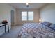 Spacious bedroom featuring neutral walls, ceiling fan, and soft lighting at 5028 Colline Ct, Charlotte, NC 28216
