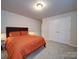 Cozy bedroom with a comfortable bed, soft lighting, and a double door closet at 5028 Colline Ct, Charlotte, NC 28216