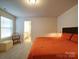 Comfortable bedroom featuring a cozy bed and adjacent bathroom entrance at 5028 Colline Ct, Charlotte, NC 28216