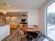 Bright dining area with a round table and modern chairs, offering a view to the outside at 5028 Colline Ct, Charlotte, NC 28216