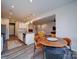 Open concept dining area connecting the kitchen to the living room, featuring a stylish round table at 5028 Colline Ct, Charlotte, NC 28216