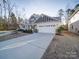 Spacious driveway leading to the home's two-car garage, with beautiful landscaping surrounding it at 5028 Colline Ct, Charlotte, NC 28216