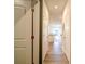 Hallway featuring hardwood floors and leading to a modern kitchen with a view of the outdoors at 5028 Colline Ct, Charlotte, NC 28216