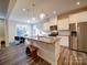 Modern kitchen with stainless steel appliances, granite countertops, and an island with bench seating at 5028 Colline Ct, Charlotte, NC 28216