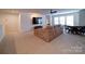 Living room with a large couch, TV, and a dining area by the windows at 5028 Colline Ct, Charlotte, NC 28216
