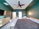 Bedroom with a ceiling fan, a white bench, a chest of drawers and green walls at 5028 Colline Ct, Charlotte, NC 28216