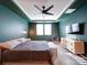 Bedroom features a ceiling fan, green walls, two windows, a chest of drawers and bench at 5028 Colline Ct, Charlotte, NC 28216