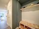 Mudroom with storage baskets, hat rack, bench seating, and view of the open concept interior at 5028 Colline Ct, Charlotte, NC 28216