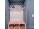 Organized mudroom with bench seating, storage baskets, and hat rack on a shelf at 5028 Colline Ct, Charlotte, NC 28216