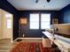 Home office with a front door, a desk with a dual monitor setup, and an area rug at 5028 Colline Ct, Charlotte, NC 28216