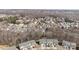 Aerial view of neighborhood showcasing mature trees and surrounding landscape at 6503 Revolutionary Trl, Charlotte, NC 28217