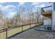 A well-kept backyard features a patio and wooded views with a black metal fence at 6503 Revolutionary Trl, Charlotte, NC 28217