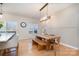 Open-concept dining area with modern light fixtures and a wooden table at 6503 Revolutionary Trl, Charlotte, NC 28217