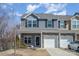 Charming townhome featuring stone accents, single-car garage, and well-maintained landscaping at 6503 Revolutionary Trl, Charlotte, NC 28217