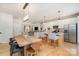 Open concept kitchen with stainless steel appliances, light wood island, and a large dining table at 6503 Revolutionary Trl, Charlotte, NC 28217