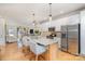 Bright kitchen featuring a large center island, stainless steel appliances and a seamless transition into the living space at 6503 Revolutionary Trl, Charlotte, NC 28217