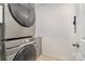 Efficient laundry area with stacked washer and dryer set, maximizing space in a compact design at 6503 Revolutionary Trl, Charlotte, NC 28217