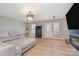 Spacious living area with wood floors, a large sectional, and natural light at 6503 Revolutionary Trl, Charlotte, NC 28217