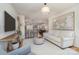 Bright living room with hardwood floors, white walls and large windows, open to the kitchen at 6503 Revolutionary Trl, Charlotte, NC 28217