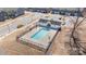 An aerial view of a community pool with a well-maintained pool house and surrounding fence at 6503 Revolutionary Trl, Charlotte, NC 28217