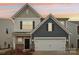 Charming two-story home featuring a two-car garage, stone accents, and warm exterior lighting at 6509 Gopher Rd, Lancaster, SC 29720