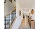 Open and airy hallway with wood floors and a staircase featuring black metal and wood railings at 6509 Gopher Rd, Lancaster, SC 29720