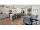 Bright kitchen and dining area featuring modern cabinets, a large island, and hardwood flooring at 6509 Gopher Rd, Lancaster, SC 29720