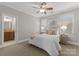 This bedroom features large, bright windows and an adjacent bathroom at 7029 Gardner Pond Ct, Charlotte, NC 28270