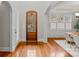 Elegant foyer featuring hardwood floors, a wood front door, and views of the dining room at 7029 Gardner Pond Ct, Charlotte, NC 28270