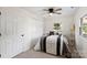 Comfortable bedroom with neutral carpet, a ceiling fan, and a double door closet at 717 Perth Rd, Troutman, NC 28166