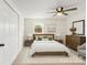 Serene bedroom with a modern bed frame, stylish decor, and a bright window view at 717 Perth Rd, Troutman, NC 28166