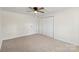 Bedroom featuring neutral carpet, a ceiling fan, and a double door closet at 717 Perth Rd, Troutman, NC 28166