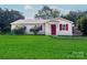 Charming one-story home with a bright red front door, shutters, and a well-manicured lawn at 717 Perth Rd, Troutman, NC 28166
