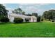 Attractive single-story house featuring green grass, bright shutters, and a neatly landscaped front yard at 717 Perth Rd, Troutman, NC 28166